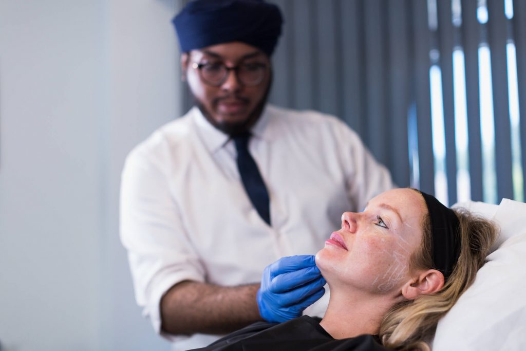 Patient receiving full face filler treatment