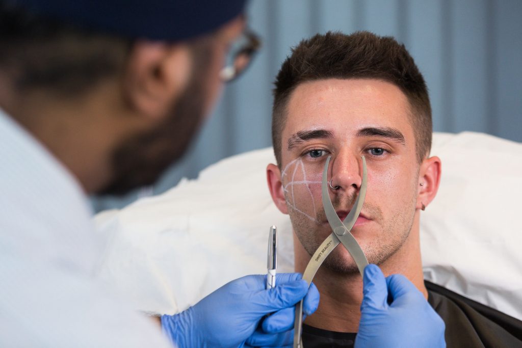 Dr measuring patient prior to filler treatment