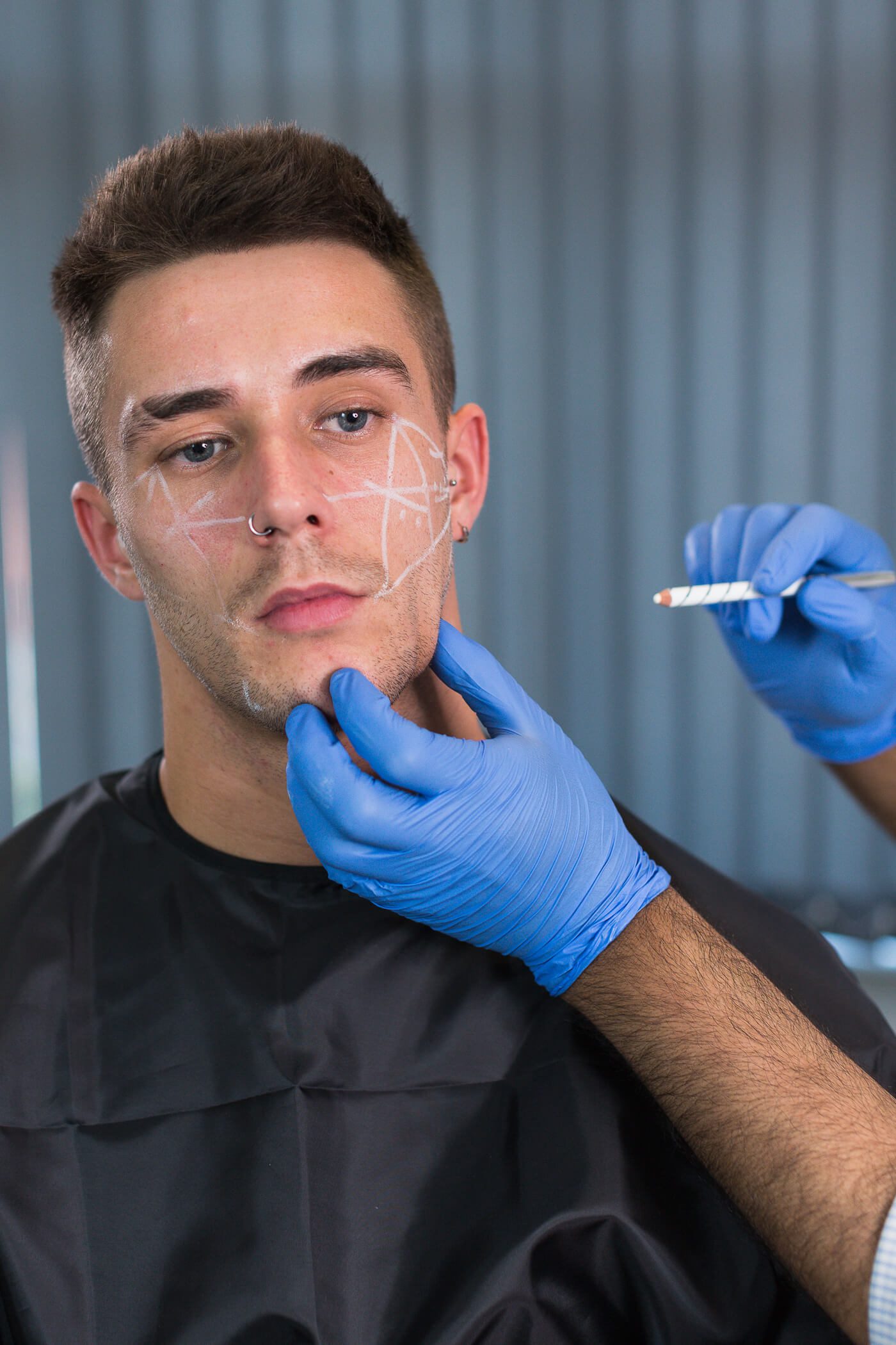 Dr drawing on patient prior to filler treatment