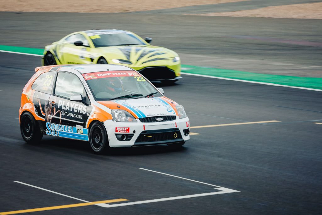 Fiesta overtaking an Aston Martin - Silverstone circuit