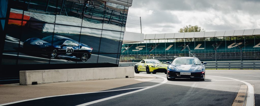 Ferrari and Aston Martin coming into the pit lane - Silverstone circuit