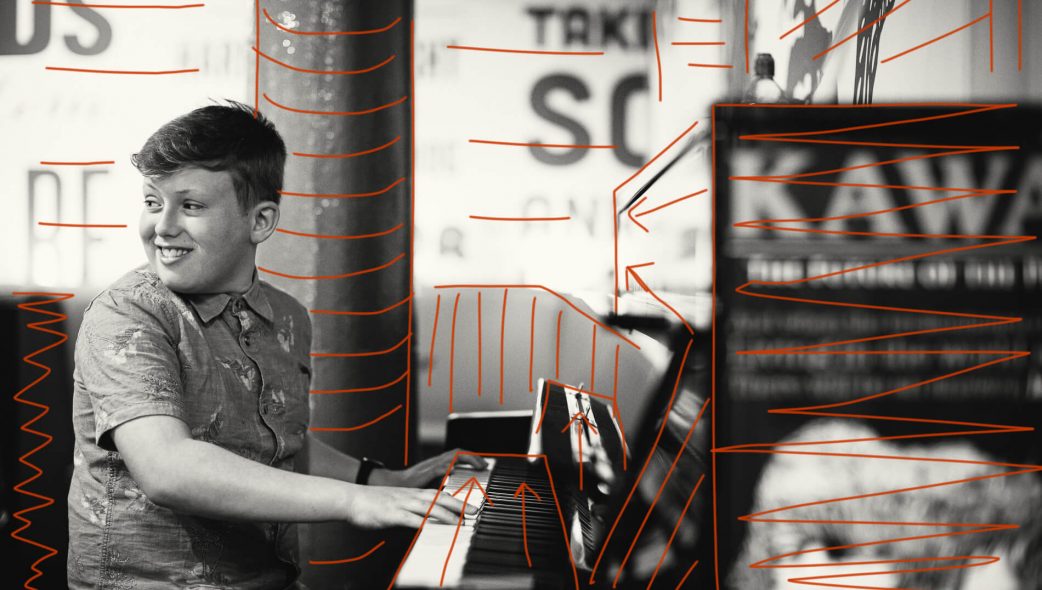 Portrait of a young man playing a piano, taken in Liverpool with annotations showing layers of depth and leading lines
