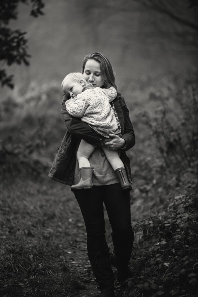 Black and white photo of a mother cuddling her daughter