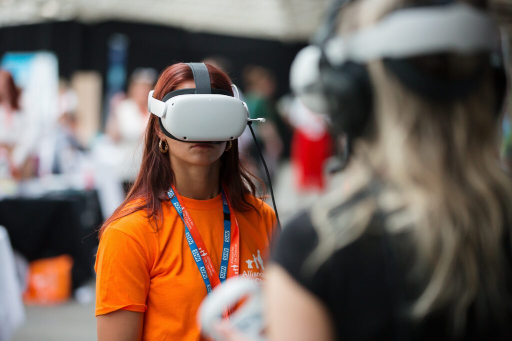 One of the event organisers tries on a virtual reality headset