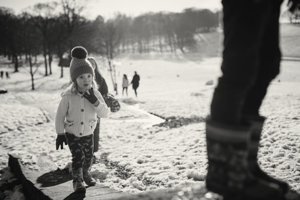Low point of view shot of young girl playing in the snow