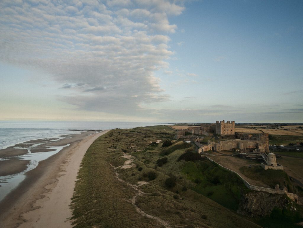 Drone photograph of Bamburgh Castle, Northumberland at sunset